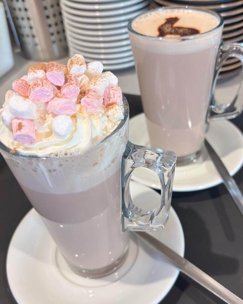 hot chocs Hot chocolates, one with cream and marshmallows and one with alpaca shaped chocolate dusting