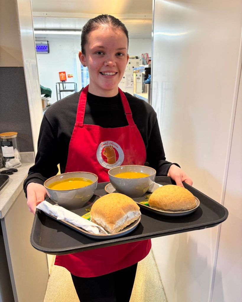 isobel Isobel serving a tray of bread and soup